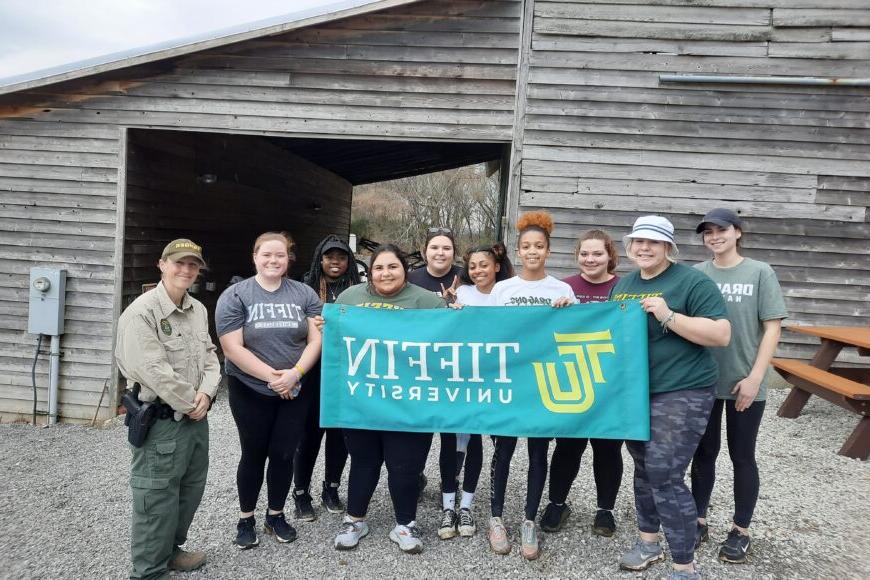 tiffin students at a bird sanctuary smiling with park ranger